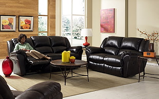 woman sitting on leather padded recliner sofa